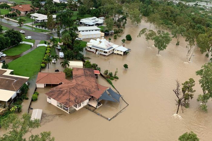 Floodwaters surrounding some homes, as seen from the air|700x467