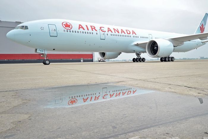 An Air Canada plane parked on the tarmac, taken on an unspecified date.|700x467